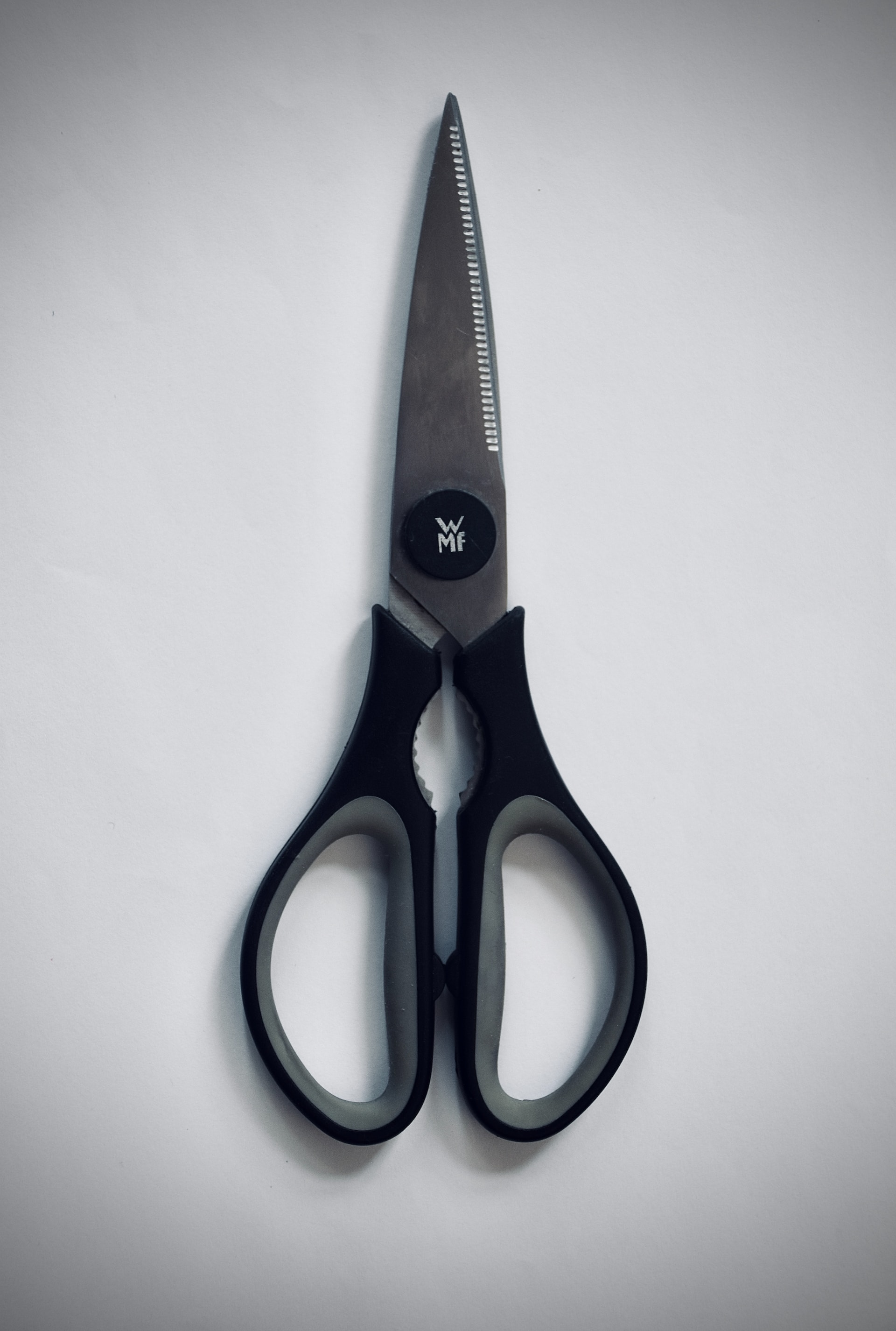 Basic closed scissors, with black handles and white 
    background